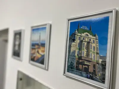 a framed picture of a building on a wall at Hardy's Apartment in Belgrade