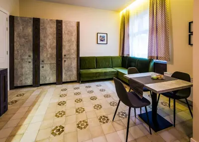 a living room with a green couch and a table at Lux Villa Old Town in Belgrade