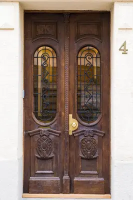 a wooden door with three windows on a building at Lux Villa Old Town in Belgrade