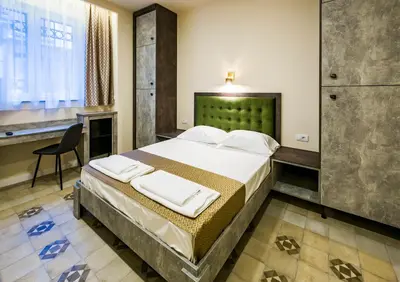 a bedroom with a bed and a desk in a room at Lux Villa Old Town in Belgrade