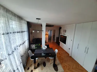 a living room with a table and a couch at Apartment New Belgrade Home in Belgrade