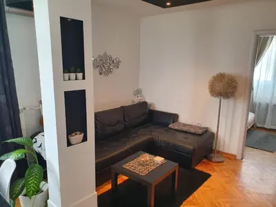 a living room with a brown leather couch and a table at Apartment New Belgrade Home in Belgrade