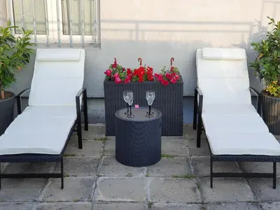 two chairs and a table with wine glasses on it at Apartment New Belgrade Home in Belgrade