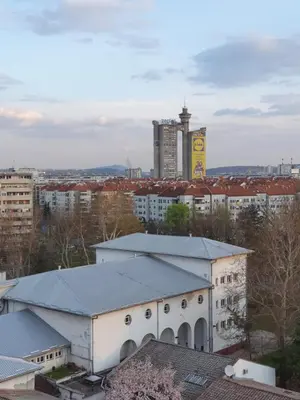 a large white building with a city in the background at Apartment New Belgrade Home in Belgrade