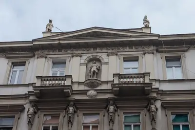 a building with a statue on the side of it at Knez Mihailova Apartman in Belgrade