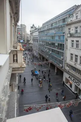 a group of people walking down a street in a city at Knez Mihailova Apartman in Belgrade