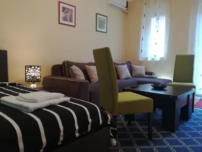 a living room with a couch and a chair at BY THE PARK free parking in Belgrade