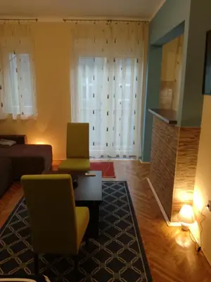 a living room with a couch and a table and chairs at BY THE PARK free parking in Belgrade