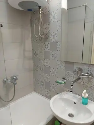 a bathroom with a sink and a shower and a mirror at BY THE PARK free parking in Belgrade