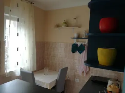 a kitchen with a table and chairs and a window at BY THE PARK free parking in Belgrade