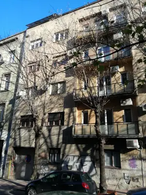 an apartment building with trees in front of it at BY THE PARK free parking in Belgrade