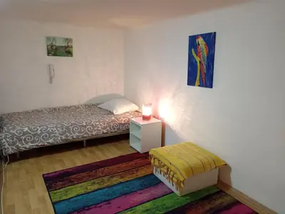 a bedroom with a bed and a table with a lamp at Kiwi Apartment in Belgrade