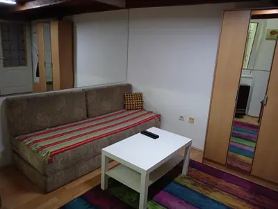 a living room with a couch and a table at Kiwi Apartment in Belgrade