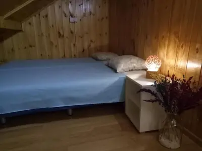 a bedroom with a bed and a table with a lamp at Tiki Apartmen in Belgrade