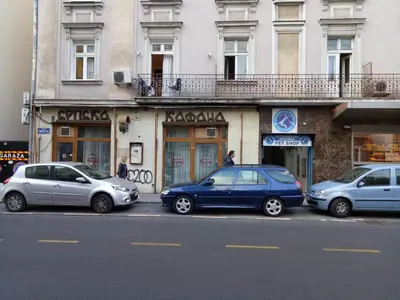 a group of cars parked in front of a building at Tiki Apartmen in Belgrade