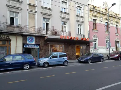 a group of cars parked on the side of a street at Tiki Apartmen in Belgrade