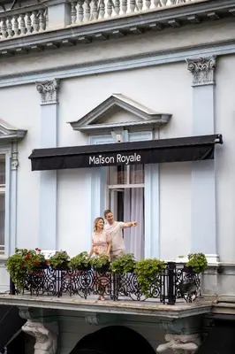 a man and a woman standing on a balcony at Maison Royale in Belgrade