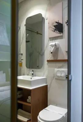 a bathroom with a sink and a toilet and a mirror at Maison Royale in Belgrade