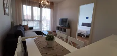 a living room with a couch and a table and a television at NIKLUK in Belgrade