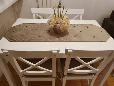 a white dining room table with two chairs at NIKLUK in Belgrade