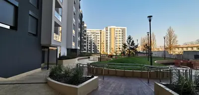 a courtyard of a building with a park and buildings at NIKLUK in Belgrade