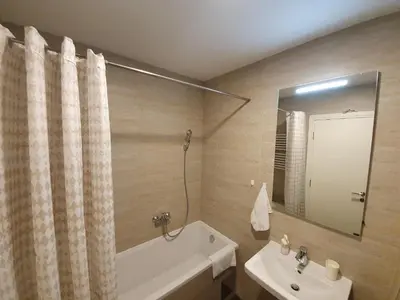 a bathroom with a tub and a sink and a bath tub at NIKLUK in Belgrade