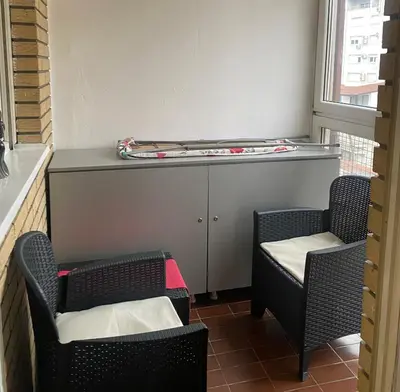 two chairs and a counter in a room with a table at Apartment Jasna in Belgrade