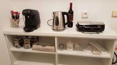 a shelf with a coffee maker and a printer on it at Apartment Jasna in Belgrade
