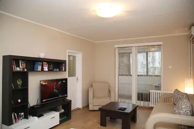 a living room with a tv and a couch at Havana Beograd Apartment in Belgrade