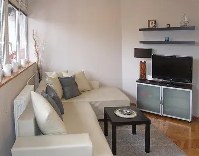 a living room with a couch and a tv at Arena Apartman in Belgrade