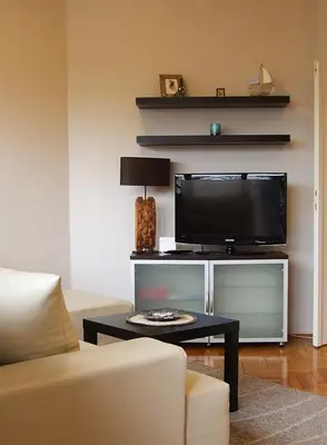 a living room with a tv and a table at Arena Apartman in Belgrade