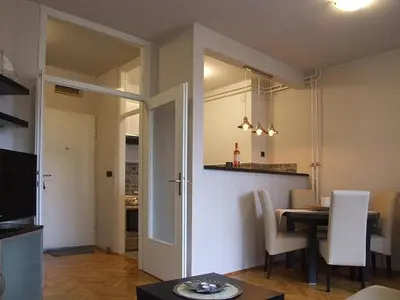 a kitchen and dining room with a table and chairs at Arena Apartman in Belgrade