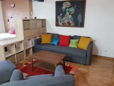 a living room with a couch with colorful pillows at Belgrade Center Apartment V in Belgrade