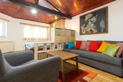a living room with a couch and a table at Belgrade Center Apartment V in Belgrade