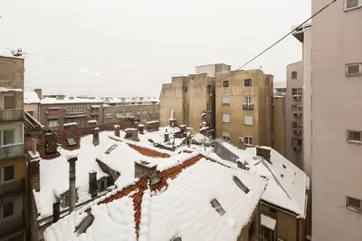 a city with snow on the roofs of buildings at Belgrade Center Apartment V in Belgrade