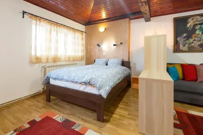 a bedroom with a bed and a couch at Belgrade Center Apartment V in Belgrade
