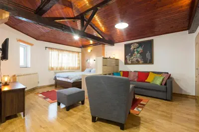 a living room with a couch and a bed at Belgrade Center Apartment V in Belgrade