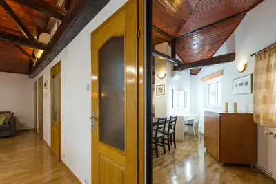 a room with a wooden door and a dining room at Belgrade Center Apartment V in Belgrade