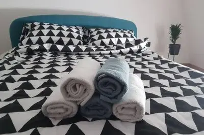 a black and white bed with towels on it at Svetogorska tri in Belgrade