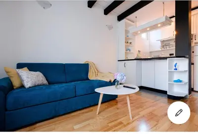a living room with a blue couch and a table at Svetogorska tri in Belgrade