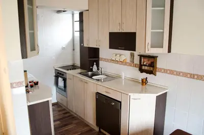 a small kitchen with a sink and a stove at Apartman White in Belgrade