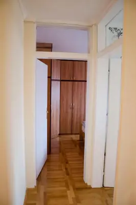 an empty room with a door and a wooden floor at Apartman White in Belgrade