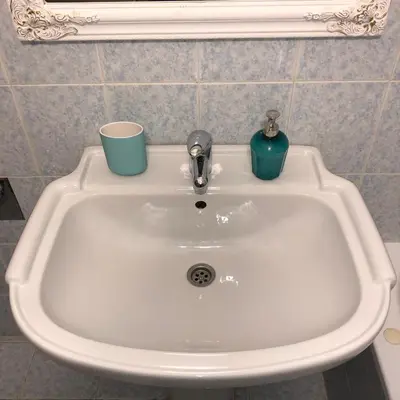 a white sink with two cups on top of it at Knez Mihailova, Beograd in Belgrade