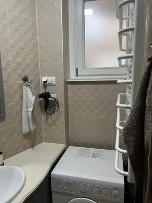 a small bathroom with a washing machine and a window at Apartment No1 in Belgrade