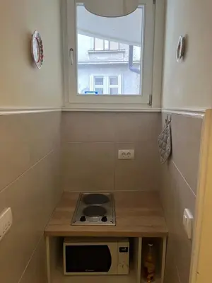a small kitchen with a stove and a window at Apartment No1 in Belgrade