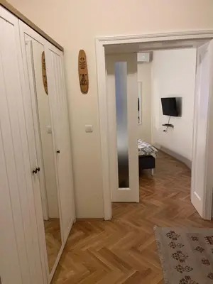 a hallway with a mirror and a room with a bed at Apartment No1 in Belgrade