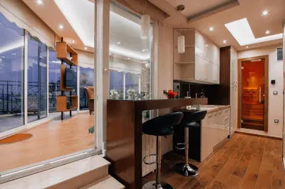 a kitchen with a bar with a view at President Lux in Belgrade