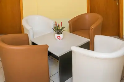 a room with two chairs and a white table and chairs at SAN 011 in Belgrade