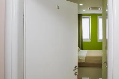 a door to a bedroom with a bed in a room at SAN 011 in Belgrade