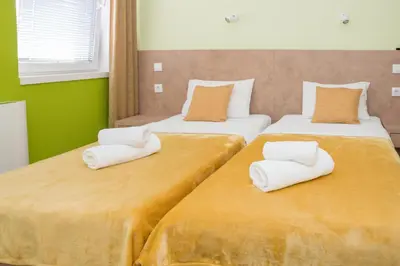 two beds with white pillows on them in a room at SAN 011 in Belgrade
